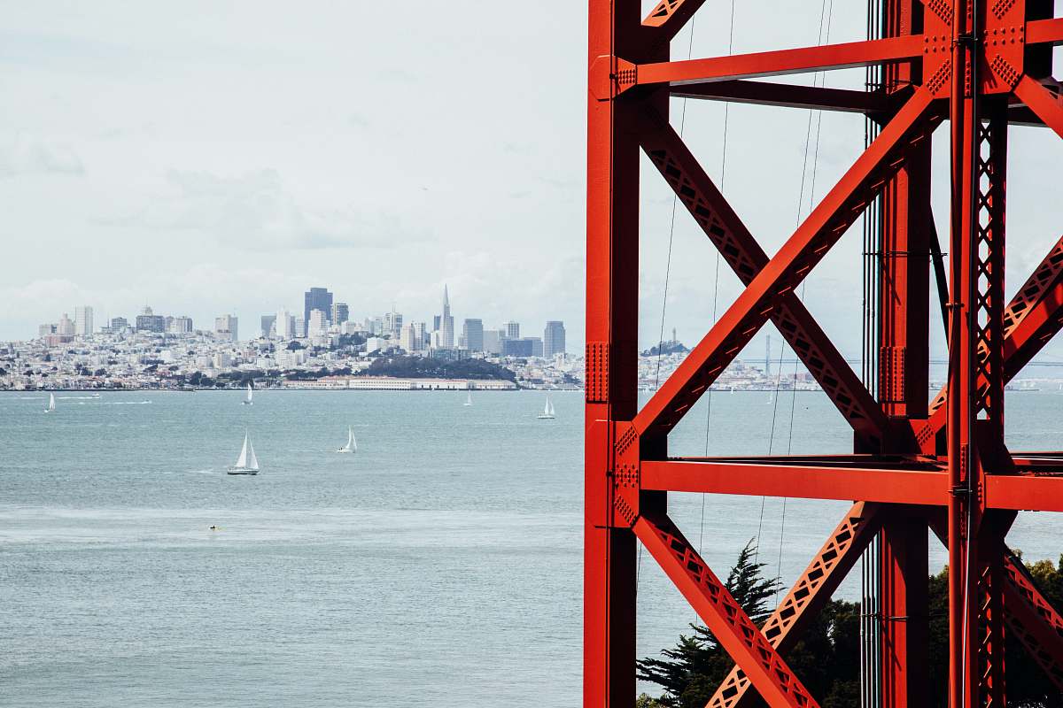 golden gate bridge boat sailing on body of water near red tower bridge
